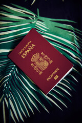 An Spanish passport over a Hawaiian bedcover - obrazy, fototapety, plakaty