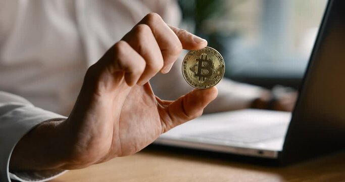 man holding bitcoin in hand. crypto investment concept