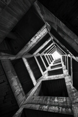 Naklejka premium Vertical Bottom view inside a building. Residential building. Geometry and precision.