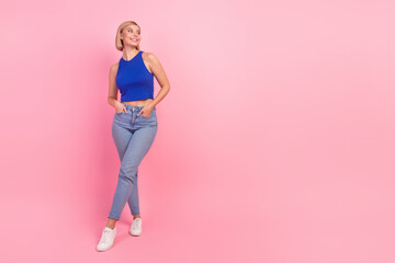 Full body photo of pretty young woman look empty space wear blue top isolated on pink color background - obrazy, fototapety, plakaty