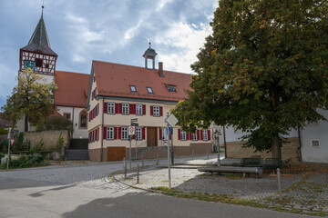Fototapeta na wymiar Old village center: Old cattle trough, old town hall and the Protestant Oswald Church in Stutttgart Weilimdorf