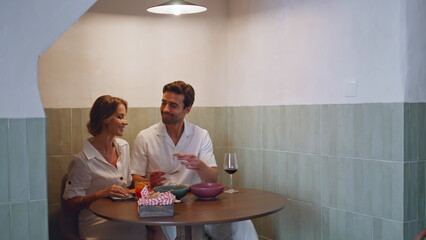 Happy couple relaxing cozy restaurant. Handsome man feeding woman in cafe table