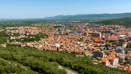 Fototapeta na wymiar Aerial view of Iglesias, an Italian municipality. It is located in southwestern Sardinia, Italy, in the Iglesiente region. It was one of the royal cities of the island and stands among the hills.