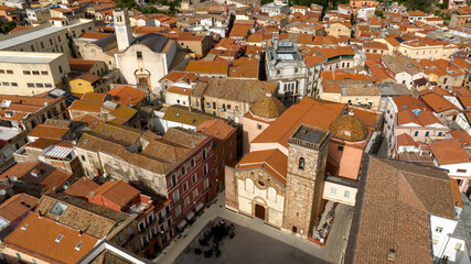 Aerial view of the Cathedral of Santa Chiara in the historic center of Iglesias, in Sardinia, Italy. It is the main church in the city and the only cathedral in the world dedicated to Clare of Assisi. - obrazy, fototapety, plakaty