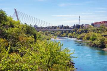 Montenegro. View of  Podgorica city and Moraca river. Millennium Bridge - obrazy, fototapety, plakaty