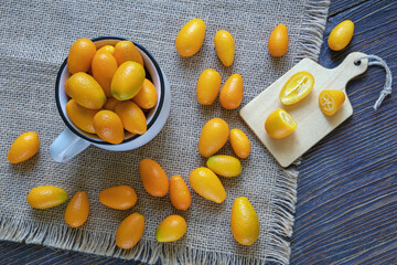 Fresh ripe kumquats on dark table