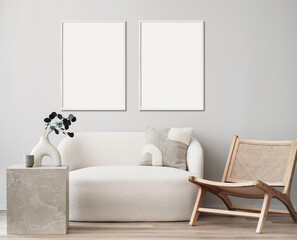 Blank picture frame mockup on white wall. Modern living room design. View of modern Boho style interior with chair, minimalism concept. Two vertical templates for artwork, painting, photo or poster - 788335727
