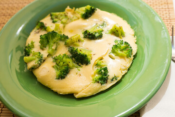 wholesome breakfast. omelet with broccoli on green plate - obrazy, fototapety, plakaty