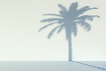 Out of focus shadow of a palm tree on a wall. Summer background