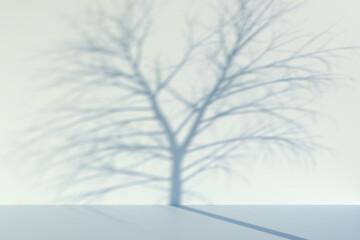 Out of focus shadow of a bare tree on a wall. Background image for autumn, winter