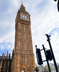 A striking view of the Elizabeth Tower, commonly known as Big Ben, standing tall against a clear...