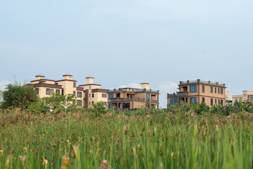 Residential buildings in urban and rural areas, the sun shines on the community at dusk and sunset