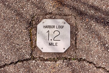 A close view of the distance marker sign on the path.