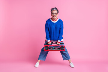 Photo of excited old woman hold boom box recorder for dancing isolated pastel color background