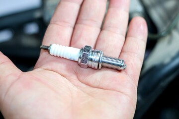 Photo of new spark plugs for change and repair with maintenance and repair concept.