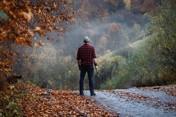 Handsome Strong Young Man in Plaid Shirt in Autumn Forest - 788363387