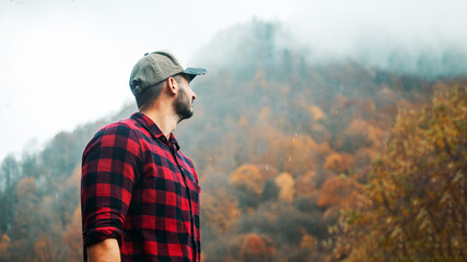 Portrait of Handsome Young Man with Cap and Checkered Shirt in Foggy Autumn Forest - 788363922