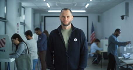 Portrait of Caucasian man, United States of America elections voter. Man with beard stands in...