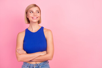 Fototapeta premium Photo of pretty young woman folded hands look empty space wear blue top isolated on pink color background