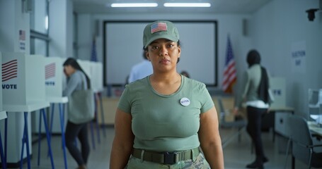 Portrait of female soldier, United States of America elections voter. Woman in camouflage uniform...