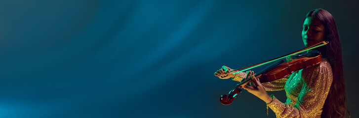 Banner. Professional violinist performing in neon light against gradient background with negative space to insert your text. Concept of art, music, hobby, classical music and modern lifestyle. Ad