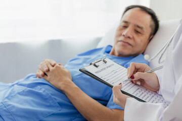 Young Asian female doctor talking with elderly man Provide care and assistance to patients in...