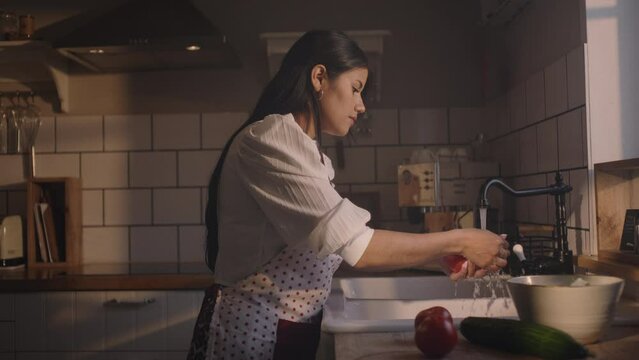 Eating strawberries, washing and preparing vegetables in the kitchen