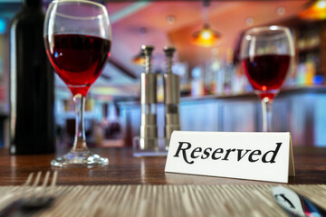 Reserved sign on restaurant table with bar background - 788386163