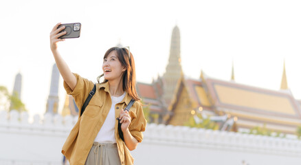 Traveler asian woman in her 30s explores the Grand Palace with a local guide. Uncover hidden gems...