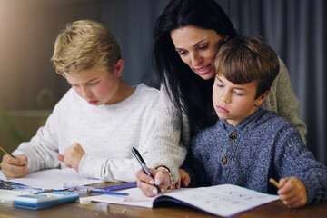 Mother, children and helping with school homework in house or learning education, teaching or lesson. Woman, sons and table in apartment for student knowledge or academic studying, writing or project