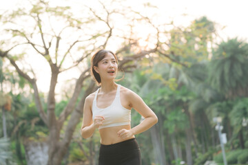 asian woman jogger running in green nature public park. - 788388347