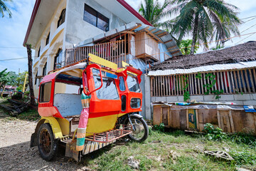 Tuktuk taxi scooter on the street of tropical town. Philippines, Siargao island.