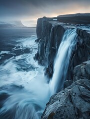 A Greenlandic waterfall cascading down a rocky cliff, highlighting the raw power of nature.
