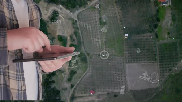 POV of a farmer using digital tablet in the vegetable farm, organic smart farm control by science technology and visual graphic display.