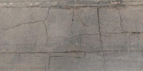 view from above on texture of asphalt road with cracks