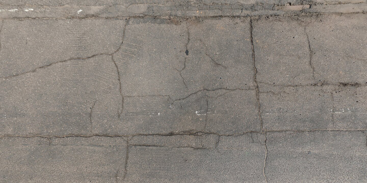view from above on texture of asphalt road with cracks