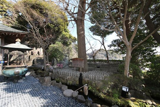 Upper level of the Hase-kannon temple complex side with Japanese Koro or insent burner and jizo statues in Kamakura, Japan in March