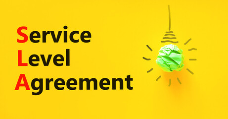SLA service level agreement symbol. Concept words SLA service level agreement on beautiful yellow...