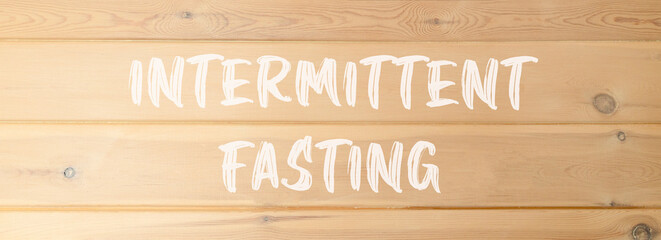 Intermittent fasting symbol. Concept words Intermittent fasting on beautiful wooden wall. Beautiful...