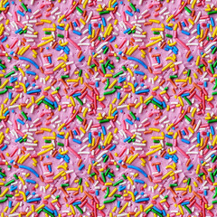 rainbow sprinkles on a pink icing background, repeatable seamless background tile