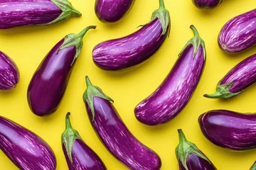  Fresh Purple Eggplants Arranged in a Group on a Vibrant Yellow Background with Center Focus © SHOTPRIME STUDIO