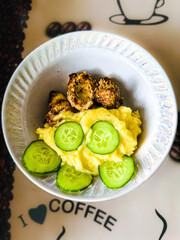 Photo of a plate with barbecued barabol and cucumbers