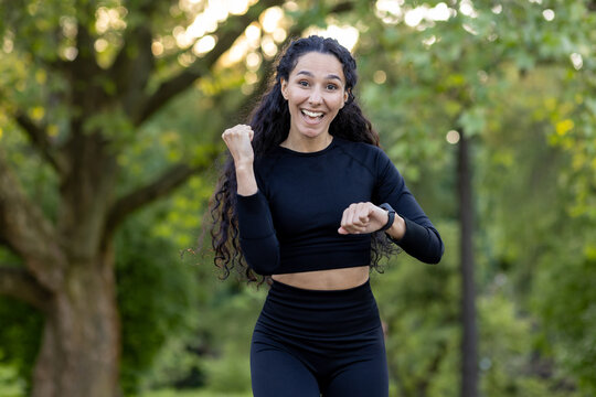 Vibrant image of a joyful Hispanic woman running in a park, expressing vitality and happiness. Perfect capture of active lifestyle and fitness enthusiasm.