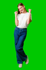 Happy Young Woman Raising Fists against green background