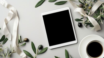 Flat lay of Coffee break inspiration with a blank digital tablet, coffee cup, decorative ribbon, and olive branches leaves on a white background. creatives backgrounds