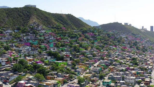 Aerial Backward Shot Of Neighborhood With Hill In City Near Mountains Against Sky - Monterrey, Mexico