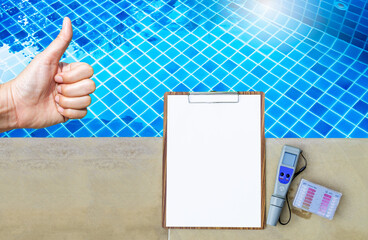 Thumbs up with clipboard and water tester on swimming pool edge, swimming pool service and maintenance concept, digital water tester for quality water test