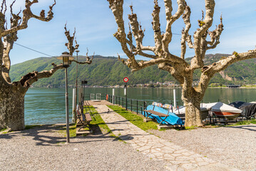 Lakefront in Bissone with the pier, overlooks of Lake Lugano, Ticino, Switzerland.