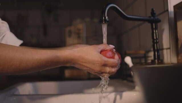 Eating strawberries, washing and preparing vegetables in the kitchen