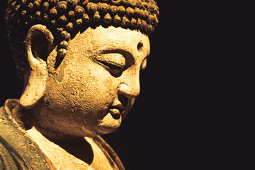 Buddha Statue - Concept of Zen, Spirituality, Peace. Copy space on Black Background